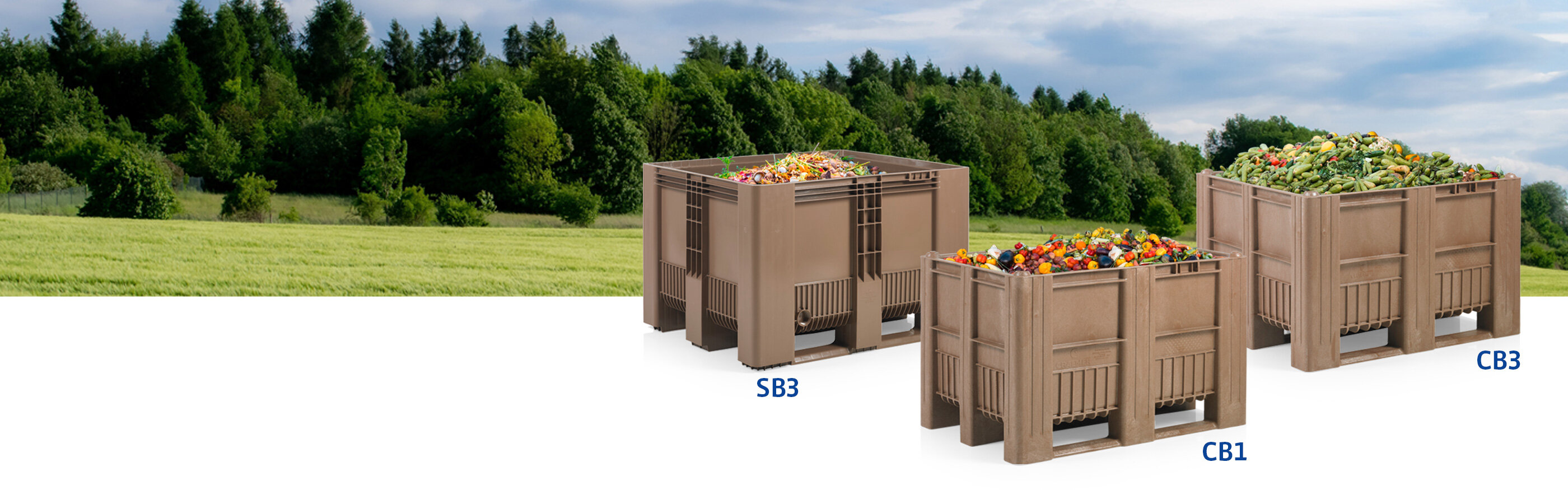 Light brown pallet boxes filled with organic waste in front of a green meadow with green trees