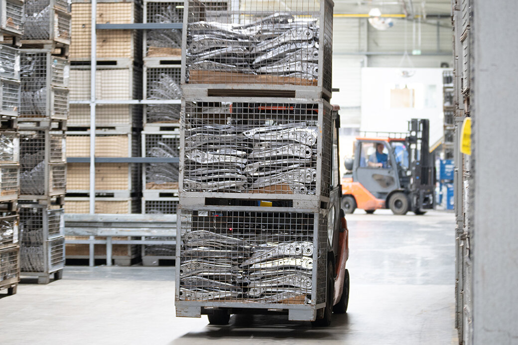 Forklift truck with grid boxes filled with metal parts